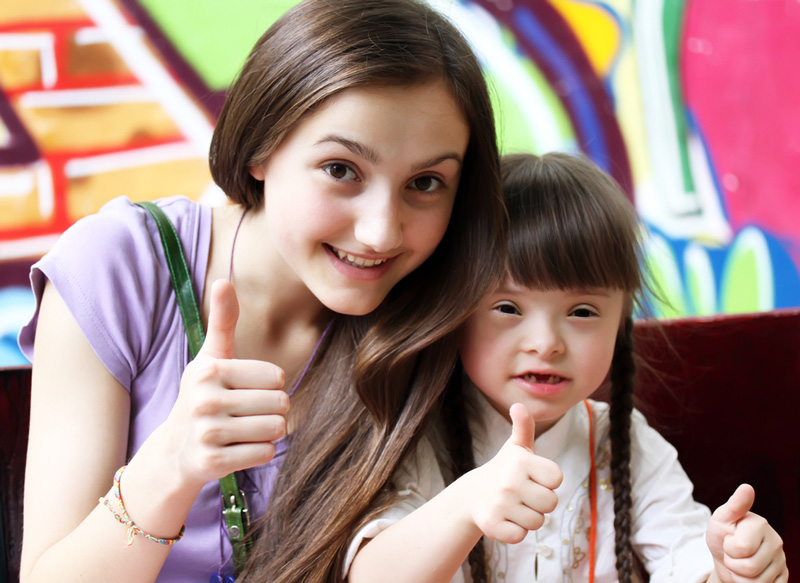 Young Girl and Care Worker Giving Thumbs Up — Disability Services In Townsville, QLD