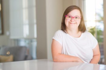 Girl With Glass Smiling Confidently — Disability Services in Cairns, QLD
