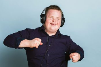 Happy Boy Listening To Music — Disability Services In Mackay, QLD