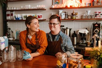 Two People Engaged in A Cheerful Conversation at The Coffee Shop Counter — Point Care Pty Ltd in Gladstone, QLD