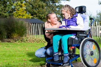 Child with Care Assistant — Disability Services in Cairns, QLD