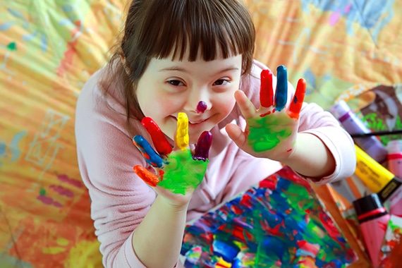 Cute Little Girl With Painted Hands — Disability Services in Rockhampton, QLD