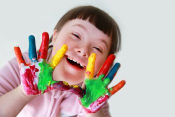 Happy Girl with Painted Hands — Disability Services in Toowoomba, QLD