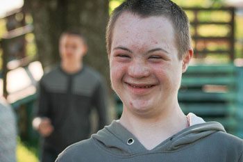 Boy Smiling WIth Down Syndrome — Disability Services & Support in Ipswich, QLD