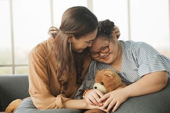 Carer Supporting Girl With Down Syndrome — Disability Services & Support in Caboolture, QLD