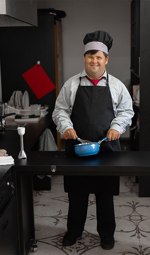 Chef Holding A Saucepan — Disability Services & Support in Sunshine Coast, QLD