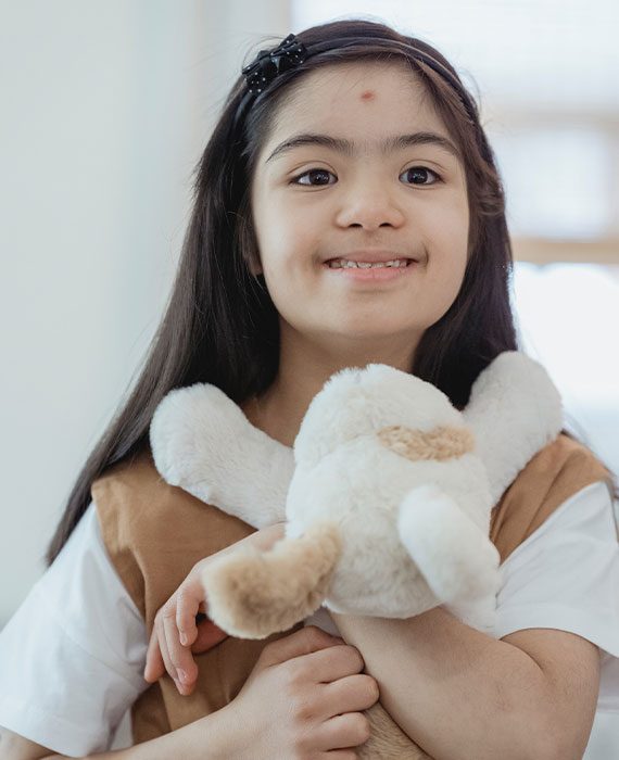 Child Holding A Teddy Bear — Disability Services & Support in Gympie, QLD