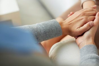 Counselor Holding Patient's Hand