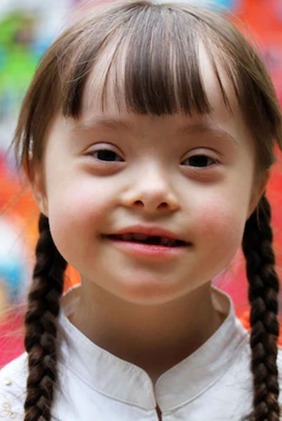 Cute Little Girl Smiling At The Camera — Disability Services & Support in Loganholme, QLD