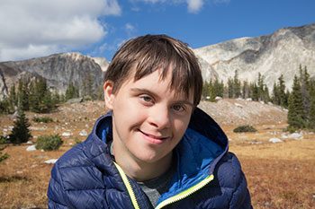 Happy Teenage Boy Hiking — Disability Services & Support in Loganholme, QLD