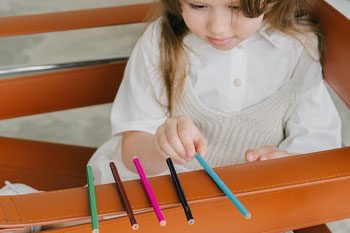 Kid Arranging Colored Pencil — Disability Services & Support in Nambour, QLD