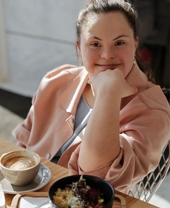 Lady With Down Syndrome Eating Breakfast — Disability Services & Support in Sunshine Coast, QLD