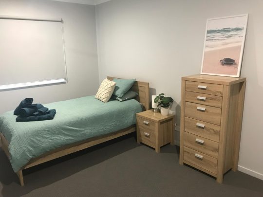 A Simple Bedroom with Wood Furniture in Trinity Beach, QLD