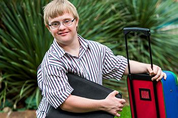Young Man With Down Syndrome Student Travelling — Disability Services & Support in Brisbane, QLD