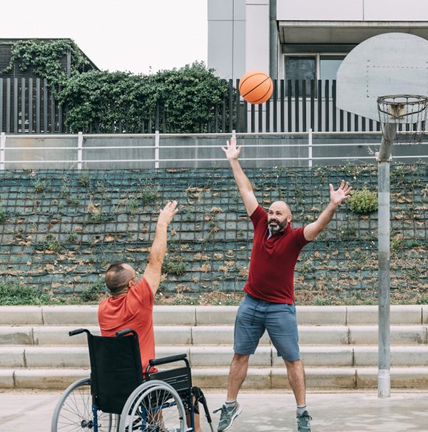 A Disabled Man in Wheelchair Throwing the Ball to Basket — Disability Services & Support in Rockhampton, QLD
