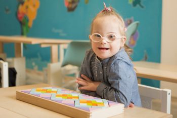 Girl With Glasses Smiling — Disability Services In Townsville, QLD